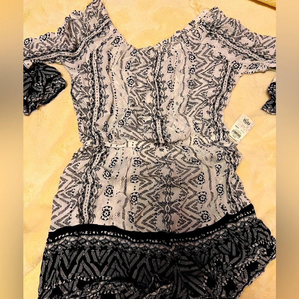 Women’s one piece shorts jumper.  Never worn.  Size small
